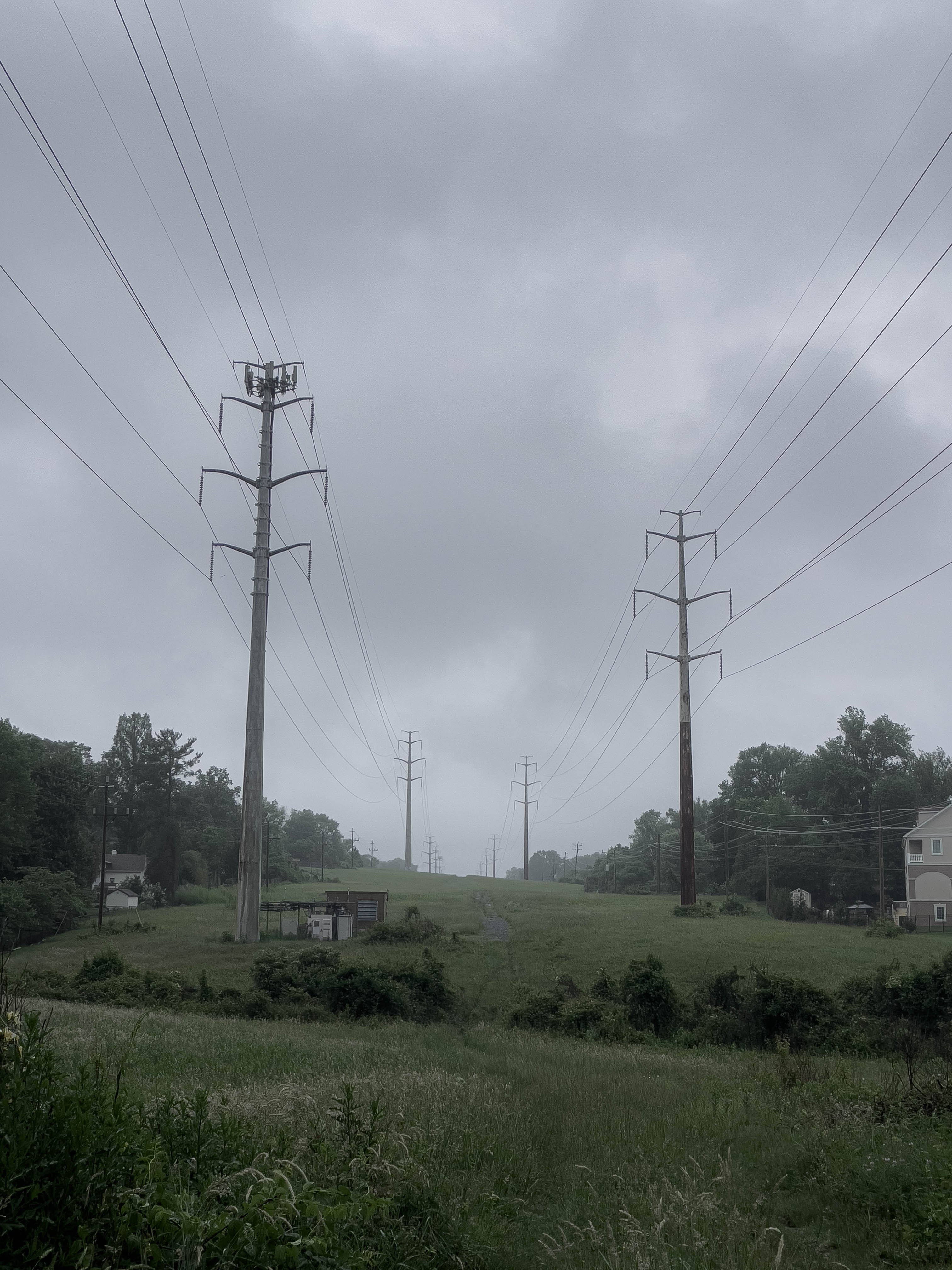 Cold imposing power lines against a cloudy sky